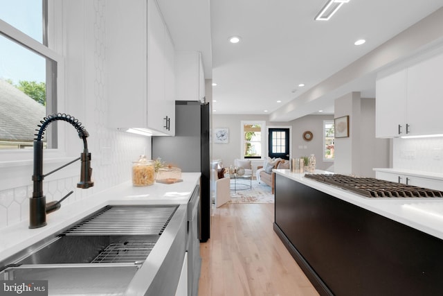 1427 Jackson St NE, Washington, DC 20017 - kitchen with a sink, backsplash, light countertops, white cabinets, and recessed lighting