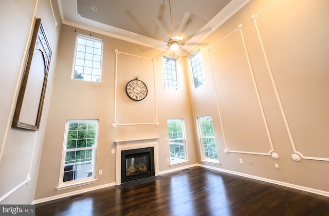 22 Thaxton Ct, Stafford, VA 22556 - unfurnished living room featuring healthy amount of natural light, a fireplace with flush hearth, a high ceiling, a ceiling fan, and wood finished floors