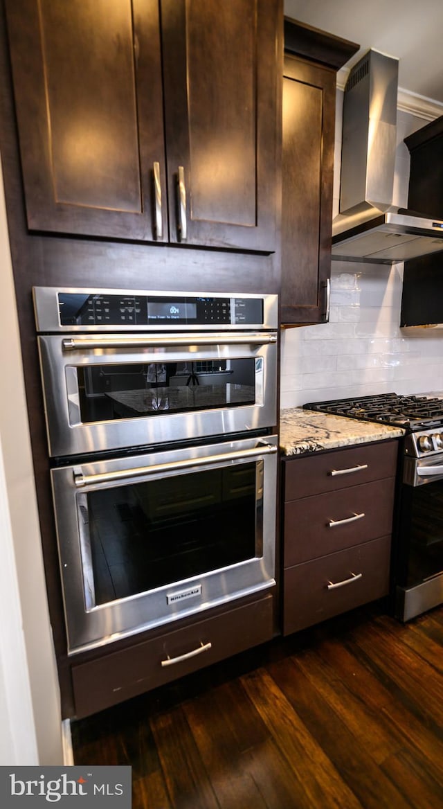 22 Thaxton Ct, Stafford, VA 22556 - kitchen featuring wall chimney range hood, appliances with stainless steel finishes, dark wood-style floors, dark brown cabinets, and light stone countertops