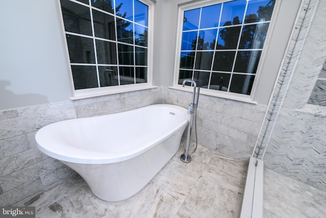22 Thaxton Ct, Stafford, VA 22556 - bathroom with tile walls, a soaking tub, marble finish floors, and a wainscoted wall