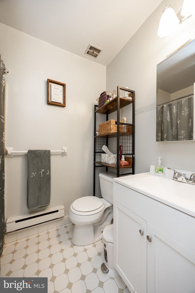 100 Winding Way Unit A-23, Downingtown, PA 19335 - full bathroom with a baseboard heating unit, toilet, vanity, tile patterned floors, and a shower with curtain