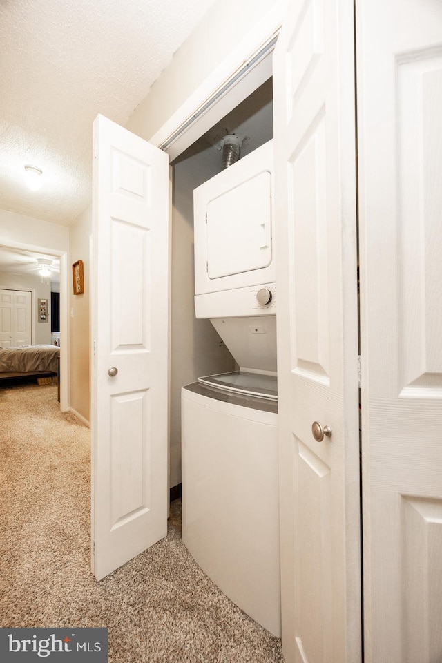 100 Winding Way Unit A-23, Downingtown, PA 19335 - laundry room with stacked washer / drying machine and carpet