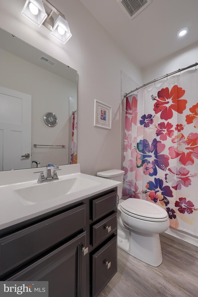 1032 Rosecroft Ln Unit 15, York, PA 17403 - bathroom featuring toilet, vanity, wood finished floors, and curtained shower
