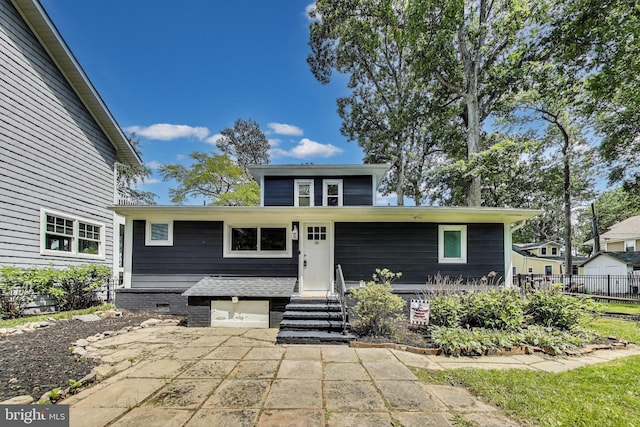 966 Walnut Ave, North Beach, MD 20714 - view of front of property featuring a garage, entry steps, a patio area, and concrete driveway