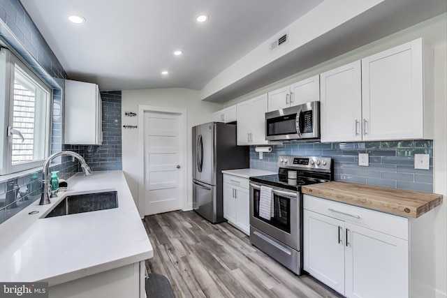 966 Walnut Ave, North Beach, MD 20714 - kitchen with stainless steel appliances, a sink, decorative backsplash, recessed lighting, and white cabinets