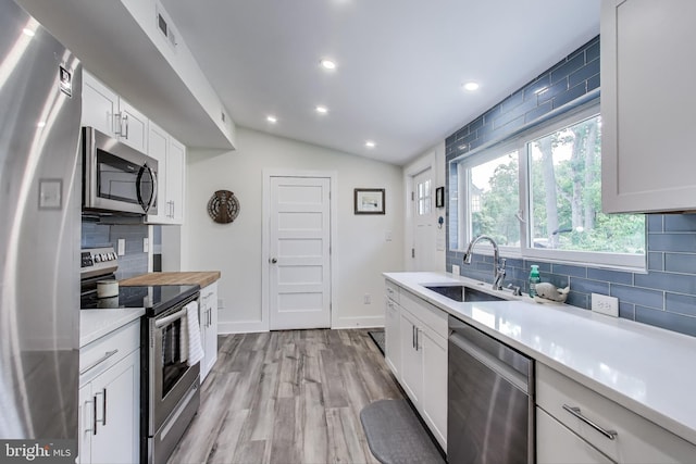 966 Walnut Ave, North Beach, MD 20714 - kitchen with stainless steel appliances, decorative backsplash, a sink, light countertops, and recessed lighting