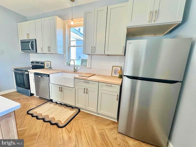 933 Mccormick Blvd, Clifton Forge, VA 24422 - kitchen featuring appliances with stainless steel finishes, a sink, light countertops, and hanging light fixtures