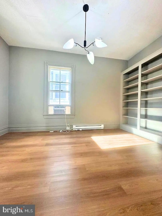 933 Mccormick Blvd, Clifton Forge, VA 24422 - unfurnished room with wood finished floors, a chandelier, and baseboards