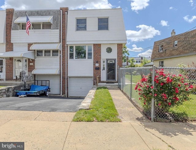 4128 Whiting Rd, Philadelphia, PA 19154 - view of property featuring a garage, driveway, and brick siding