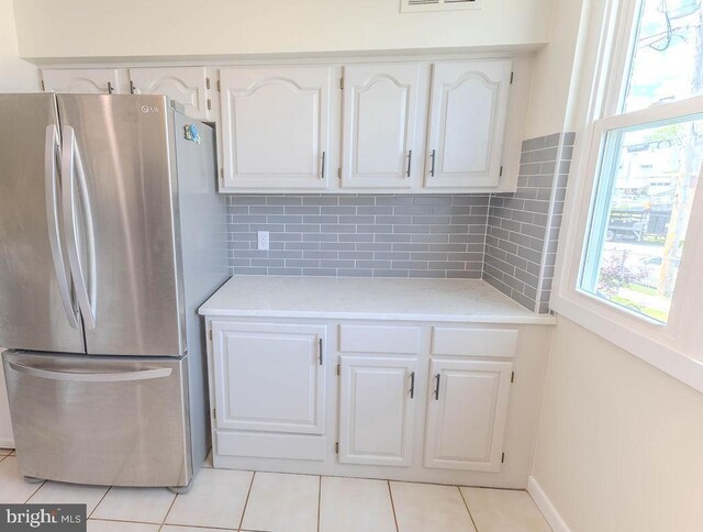 4128 Whiting Rd, Philadelphia, PA 19154 - kitchen featuring freestanding refrigerator, white cabinets, light countertops, light tile patterned floors, and backsplash