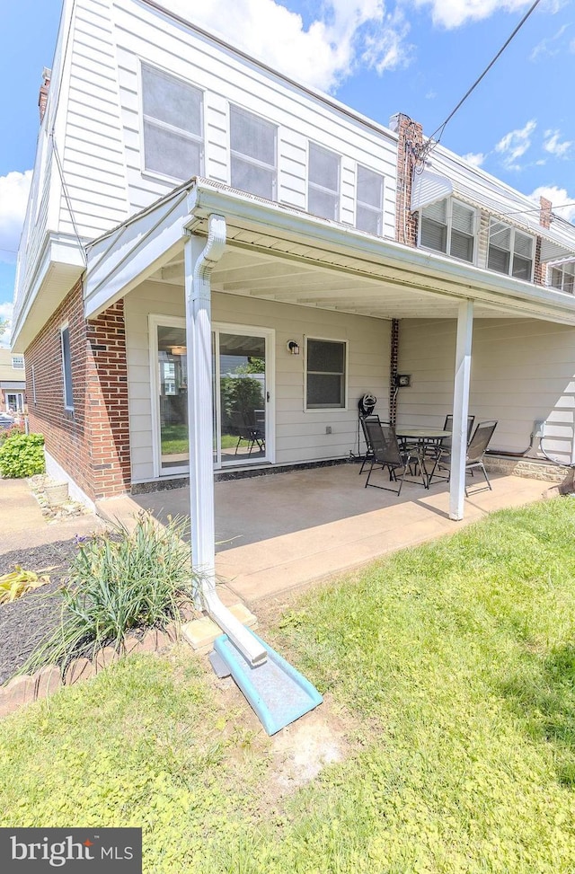 4128 Whiting Rd, Philadelphia, PA 19154 - back of property featuring brick siding and a patio area