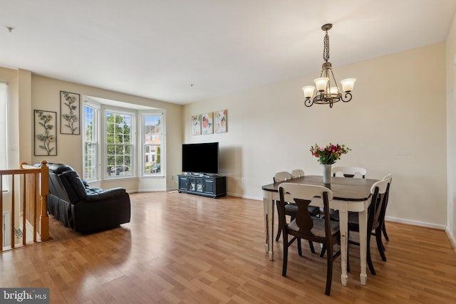 7140 Ladd Cir, Frederick, MD 21703 - dining area with a chandelier, light wood-type flooring, and baseboards