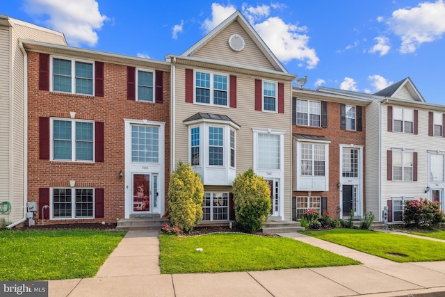 7140 Ladd Cir, Frederick, MD 21703 - townhome / multi-family property featuring a front yard and brick siding