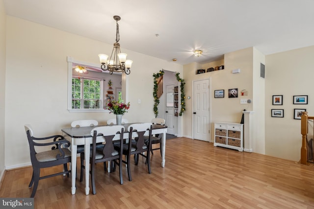 7140 Ladd Cir, Frederick, MD 21703 - dining space with light wood-style floors and a chandelier