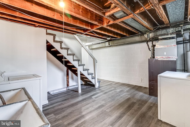 151 Bennett Rd, Essex, MD 21221 - basement with washing machine and dryer, wood finished floors, stairs, and concrete block wall