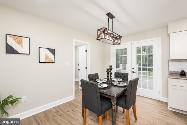 81 Rivers End Dr, Seaford, DE 19973 - dining room featuring french doors, light wood-style floors, baseboards, and a chandelier