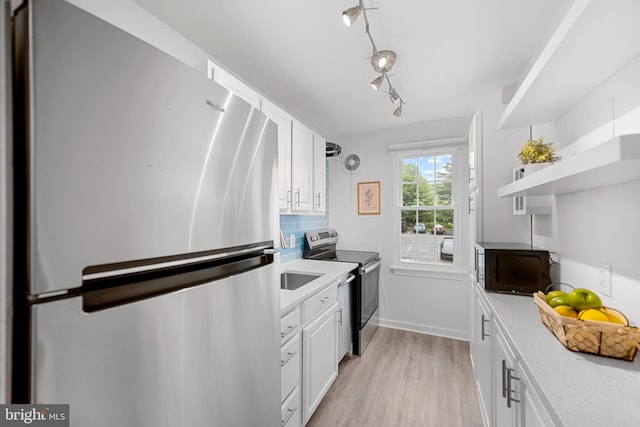 117 E Glebe Rd Unit C, Alexandria, VA 22305 - kitchen featuring stainless steel appliances, light countertops, open shelves, and white cabinets