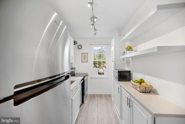 117 E Glebe Rd Unit C, Alexandria, VA 22305 - kitchen featuring appliances with stainless steel finishes, light wood-style floors, white cabinetry, baseboards, and open shelves