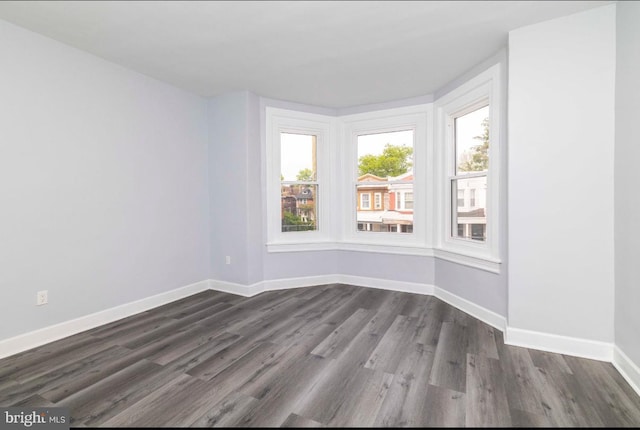 4605 N 13th St, Philadelphia, PA 19140 - spare room featuring dark wood-type flooring and baseboards