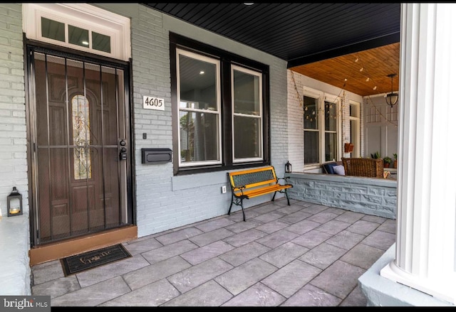 4605 N 13th St, Philadelphia, PA 19140 - property entrance featuring covered porch and brick siding