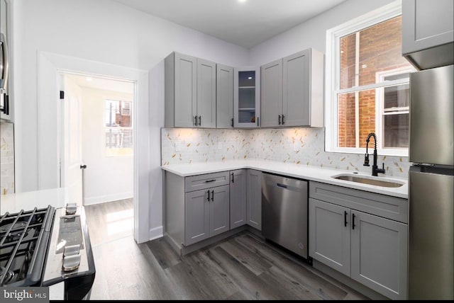 4605 N 13th St, Philadelphia, PA 19140 - kitchen featuring appliances with stainless steel finishes, gray cabinetry, a sink, and dark wood-type flooring