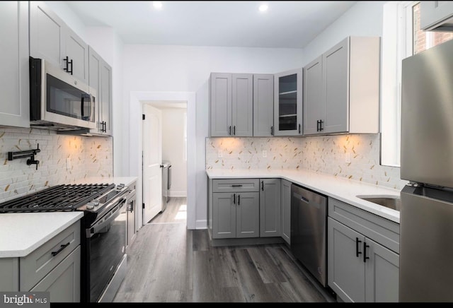 4605 N 13th St, Philadelphia, PA 19140 - kitchen featuring stainless steel appliances, gray cabinetry, tasteful backsplash, glass insert cabinets, and recessed lighting