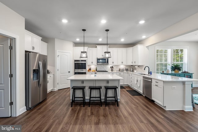 9909 Kildore Way, Fort Washington, MD 20744 - kitchen featuring appliances with stainless steel finishes, a sink, a peninsula, dark wood-type flooring, and recessed lighting