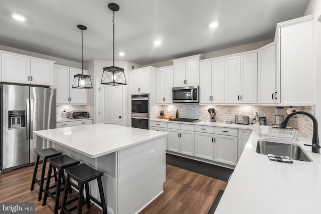 9909 Kildore Way, Fort Washington, MD 20744 - kitchen with stainless steel appliances, a sink, a center island, backsplash, and dark wood finished floors