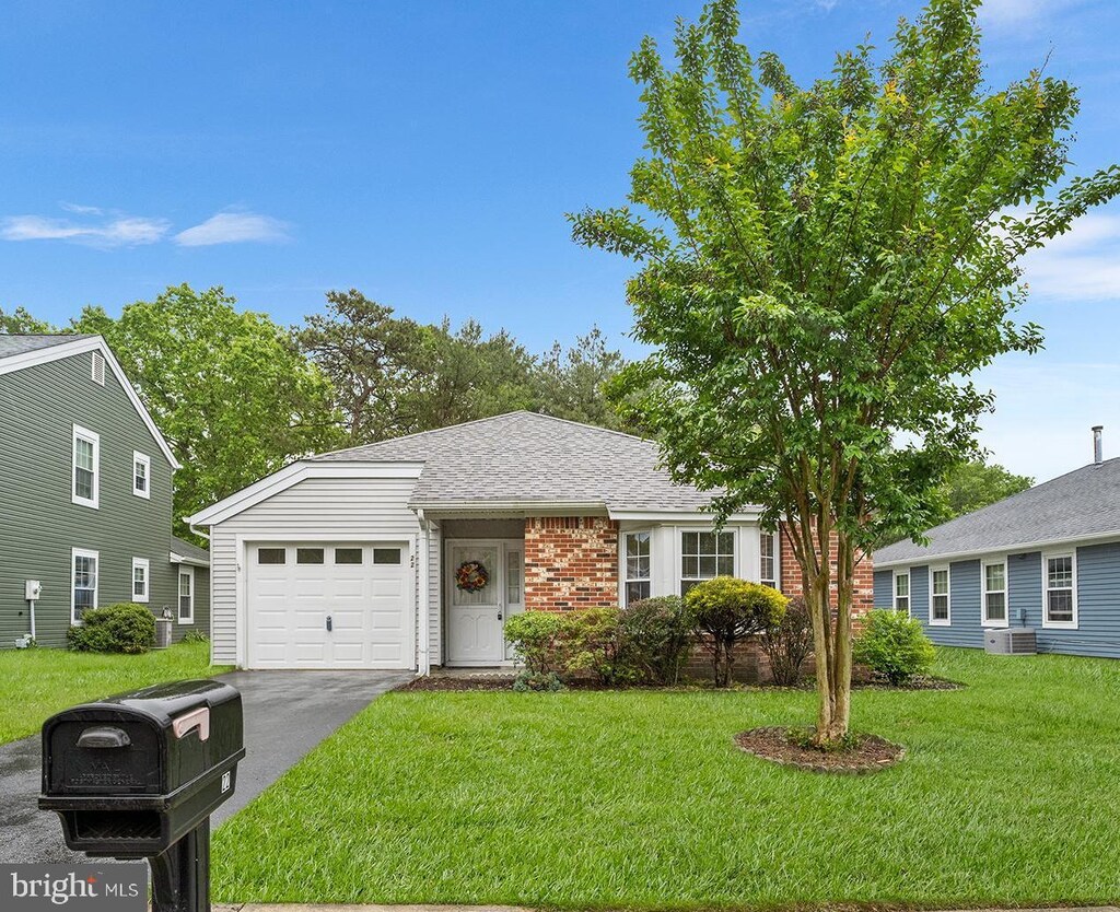 22 Pine Oak Blvd, Barnegat, NJ 08005 - ranch-style home with an attached garage, brick siding, a front yard, asphalt driveway, and central air condition unit