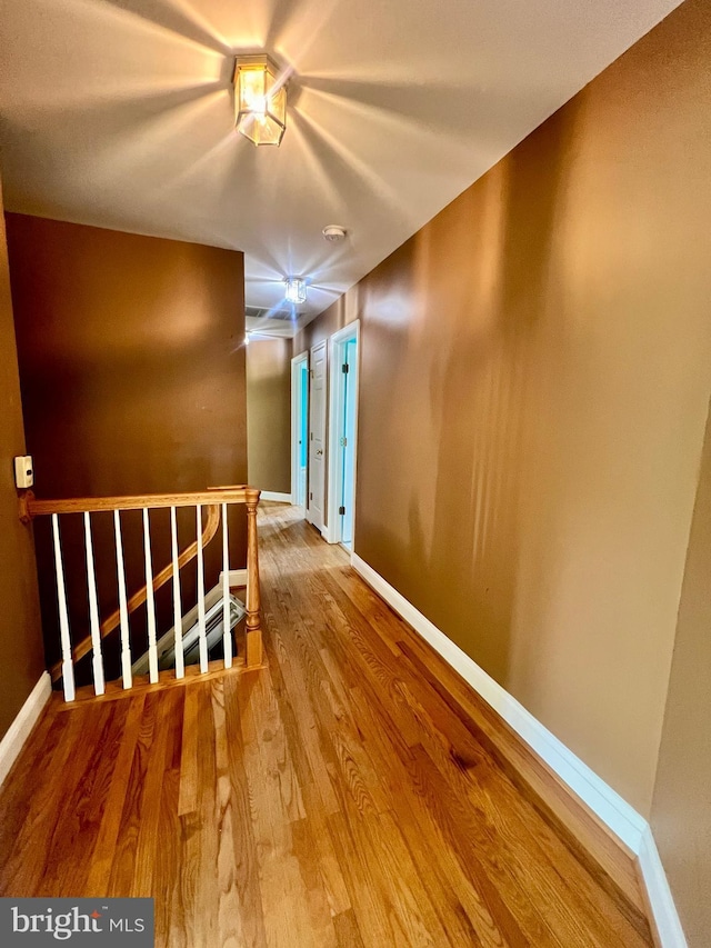 614 Wolfe Reserve Way, Harwood, MD 20776 - hallway featuring wood finished floors, baseboards, and an upstairs landing