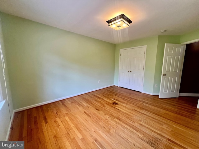 614 Wolfe Reserve Way, Harwood, MD 20776 - unfurnished bedroom featuring wood finished floors, baseboards, and a closet