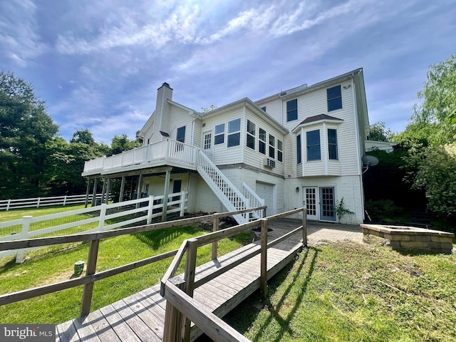 614 Wolfe Reserve Way, Harwood, MD 20776 - rear view of house featuring a wooden deck, a chimney, an attached garage, and brick siding