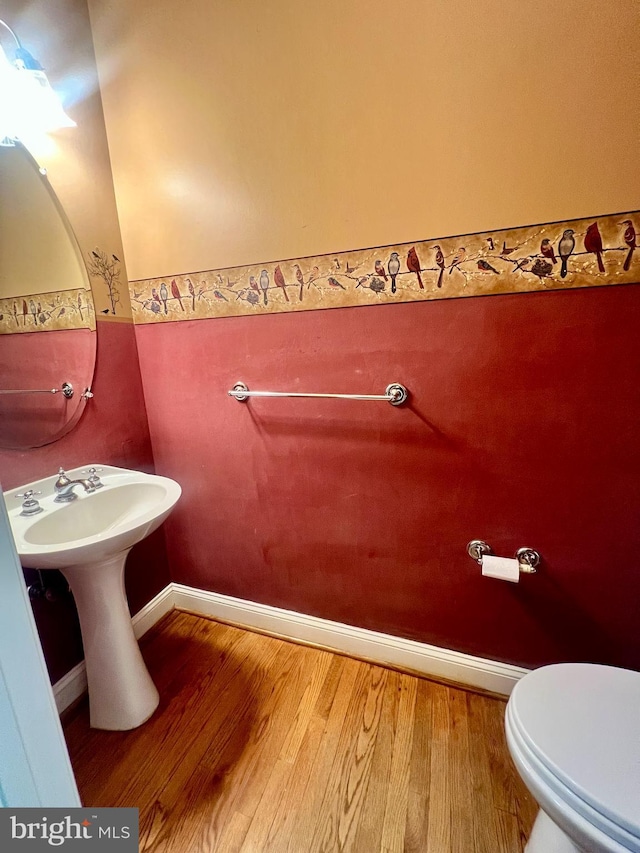 614 Wolfe Reserve Way, Harwood, MD 20776 - half bathroom with wood finished floors, toilet, and baseboards