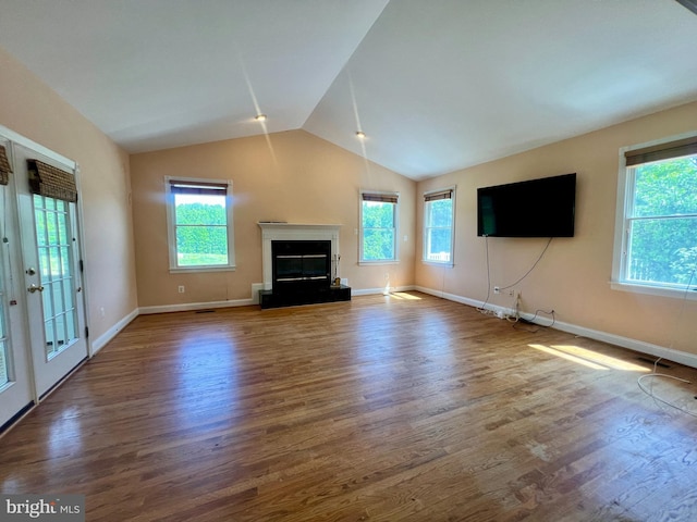 614 Wolfe Reserve Way, Harwood, MD 20776 - unfurnished living room with wood finished floors, plenty of natural light, vaulted ceiling, and baseboards