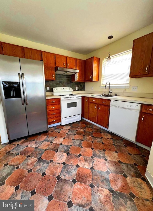 65 Auckland Dr, Newark, DE 19702 - kitchen with white appliances, under cabinet range hood, light countertops, and brown cabinetry