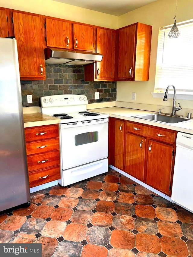 65 Auckland Dr, Newark, DE 19702 - kitchen with white appliances, under cabinet range hood, a sink, light countertops, and decorative backsplash