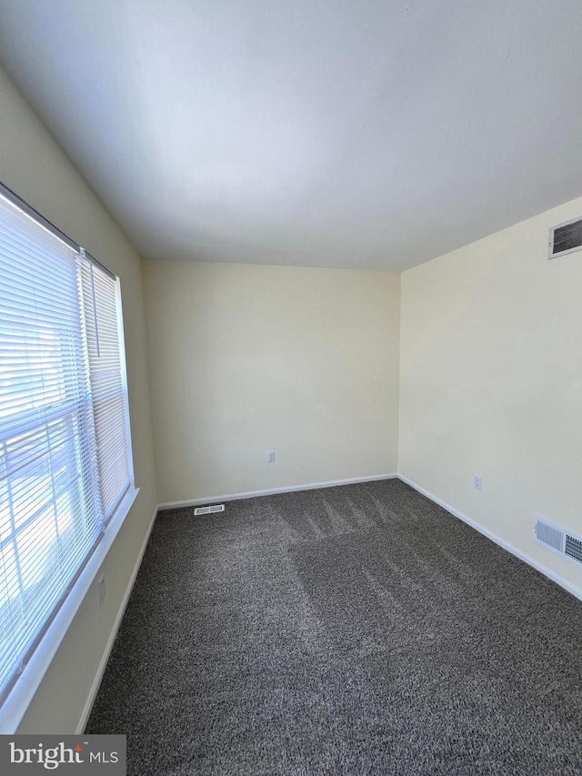 65 Auckland Dr, Newark, DE 19702 - empty room featuring dark colored carpet and baseboards