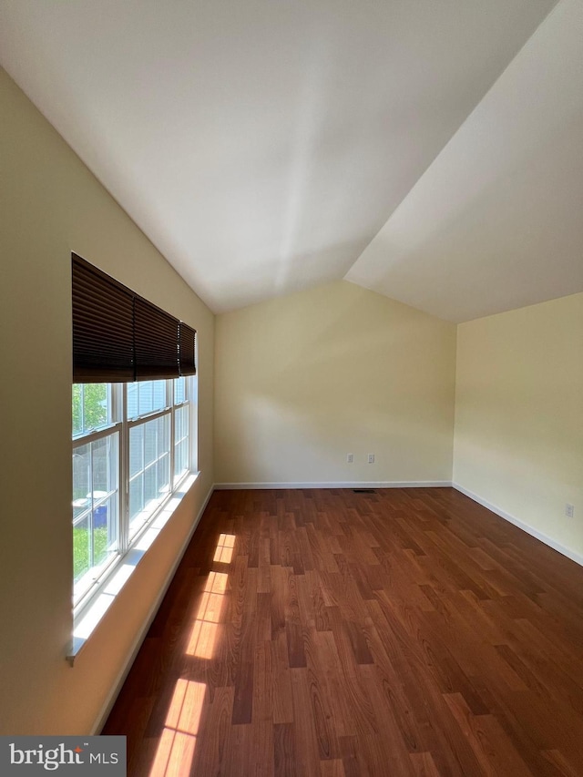 65 Auckland Dr, Newark, DE 19702 - unfurnished room featuring vaulted ceiling, wood finished floors, and baseboards