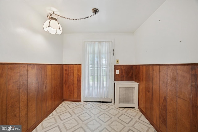 1100 Drexel Ave, Drexel Hill, PA 19026 - empty room featuring wood walls, a wainscoted wall, light floors, and radiator heating unit