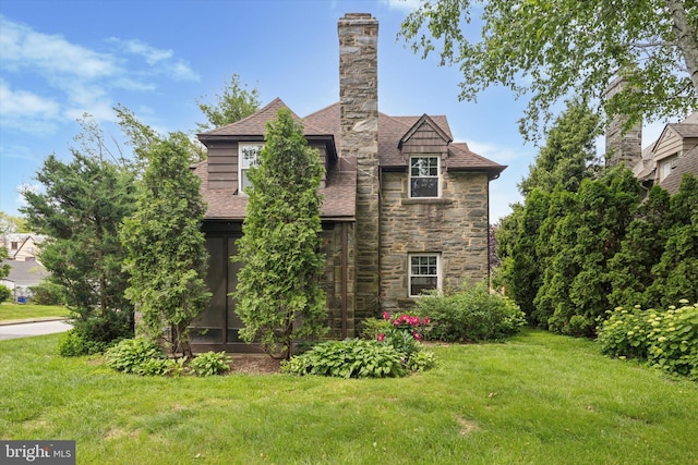 1100 Drexel Ave, Drexel Hill, PA 19026 - view of property exterior featuring stone siding, a yard, roof with shingles, and a chimney