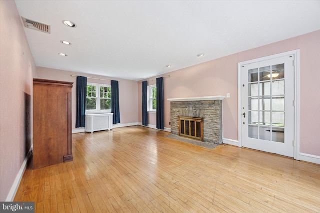 1100 Drexel Ave, Drexel Hill, PA 19026 - unfurnished living room featuring radiator heating unit, a fireplace, light wood-type flooring, baseboards, and recessed lighting
