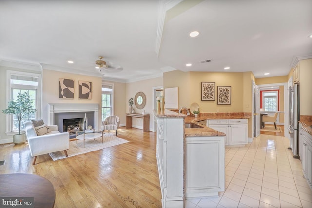 2053 Mayfair Mclean, Falls Church, VA 22043 - kitchen featuring high end fridge, a sink, crown molding, a fireplace, and open floor plan
