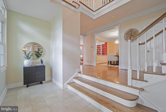 2053 Mayfair Mclean, Falls Church, VA 22043 - foyer entrance with stairway, crown molding, baseboards, tile patterned flooring, and a chandelier