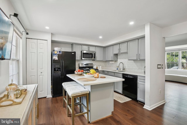 14617 Woodspring Ct, Centreville, VA 20120 - kitchen with black appliances, gray cabinetry, a sink, light countertops, and decorative backsplash
