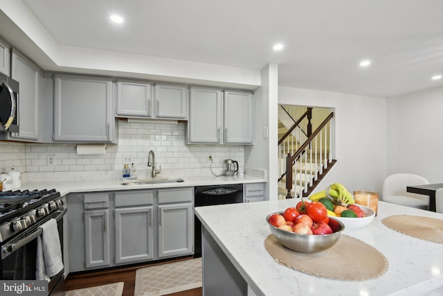 14617 Woodspring Ct, Centreville, VA 20120 - kitchen featuring gray cabinetry, a sink, gas stove, decorative backsplash, and dark wood finished floors