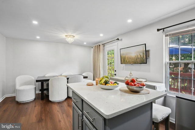 14617 Woodspring Ct, Centreville, VA 20120 - kitchen with gray cabinetry, recessed lighting, plenty of natural light, a kitchen island, and a breakfast bar