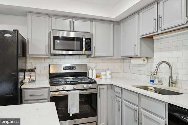 14617 Woodspring Ct, Centreville, VA 20120 - kitchen with black appliances, a sink, backsplash, and gray cabinetry