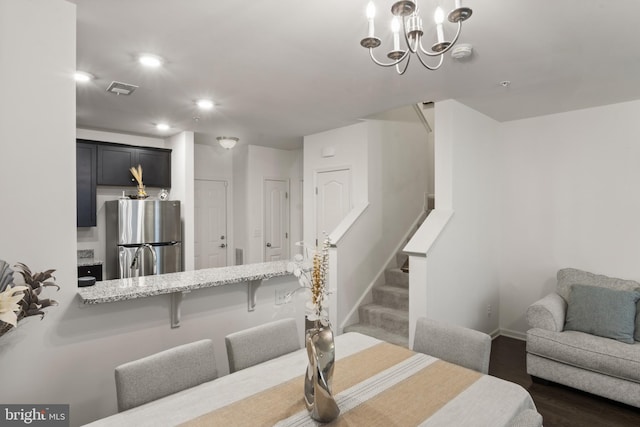 16894 Porters Inn Dr, Dumfries, VA 22026 - dining room with stairs, baseboards, dark wood-style flooring, recessed lighting, and a chandelier