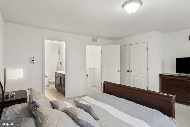 16894 Porters Inn Dr, Dumfries, VA 22026 - bedroom with a closet, light colored carpet, ensuite bath, and baseboards
