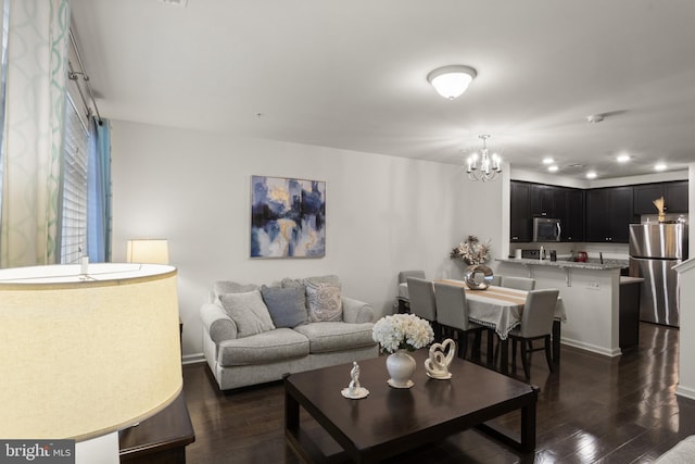 16894 Porters Inn Dr, Dumfries, VA 22026 - living area with dark wood finished floors, a chandelier, recessed lighting, and baseboards
